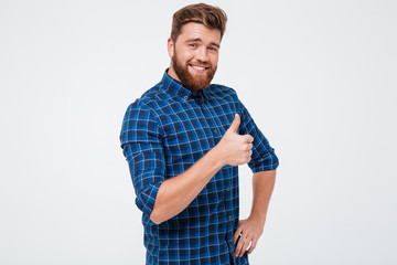 Positive man showing thumb up isolated