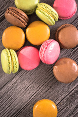 colorful macaroons on a wooden background