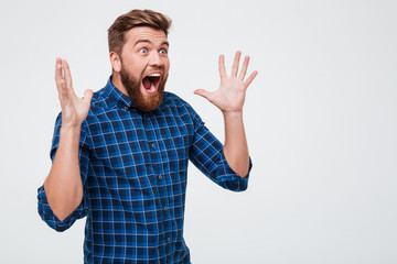 Screaming shocked man looking at copy space