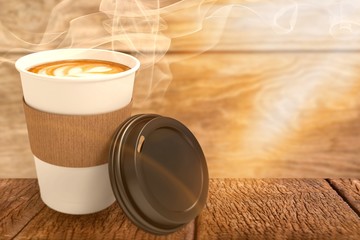 Composite image of coffee on white cup in front of its cover