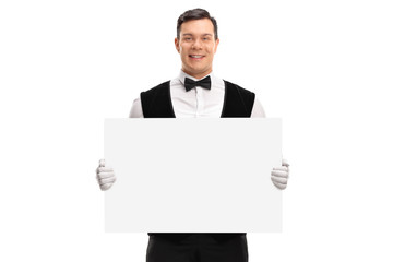 Waiter holding a blank cardboard sign and smiling