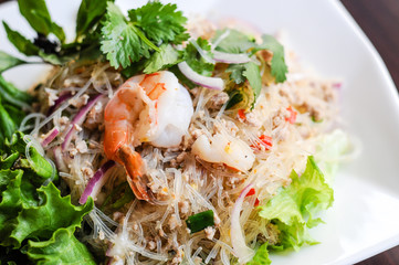 Yum Woonsen Glass Noodle Salad, Glass noodles salad served on a bed of lettuce with chicken and shrimp.