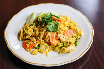 Curry Fried Rice, Stir-fried with egg, onions, green peas, carrots and seasoned with curry powder.