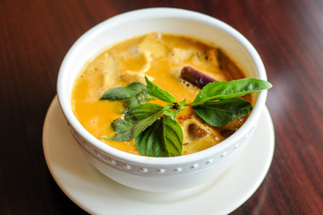 Red Curry, A delicate mix of red curry in coconut milk with eggplant, bamboo shoots, bell peppers and sweet basil leaves.