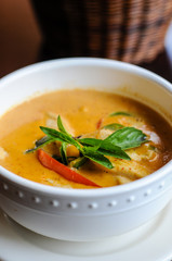Red Curry, A delicate mix of red curry in coconut milk with eggplant, bamboo shoots, bell peppers and sweet basil leaves.