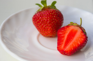 half of the cut fresh ripe strawberries, macro photo
