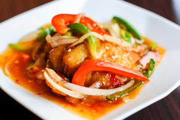 Red Hot Snapper, Fried red snapper fillet topped with hot peppers, onions, fresh garlic & bell peppers mixed in sweet & sour sauce.