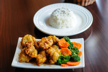 Sesame Chicken, Lightly breaded chicken with broccoli, carrots and sesame seeds.