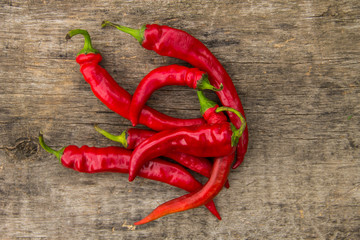 Red hot chili peppers on wooden table
