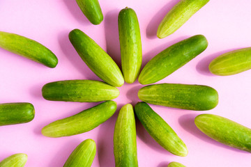top view green cucumber and pink background