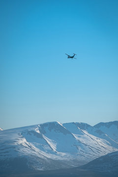 Small passenger plane over a remote snowy mountains.