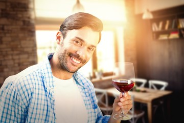 Composite image of smiling man with red wine