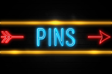 Obraz premium Pins - fluorescent Neon Sign on brickwall Front view