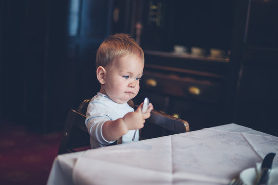 Baby in high chair at table