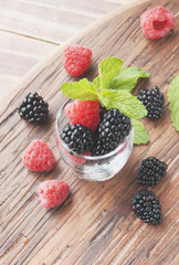 black berries and raspberries in a glass cup