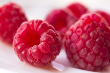 raspberries on a white saucer close up