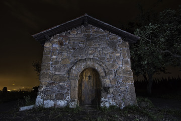 Plakat hermitage at night in basque country