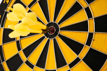 Yellow three darts arrows in the target center