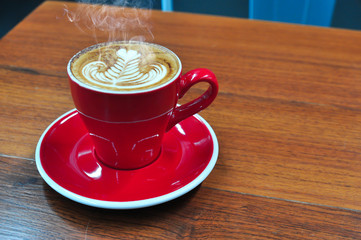 Coffee cup in coffee shop,red Cup of coffee on a wooden table,cup of coffee on table in cafe,cup of cappuccino