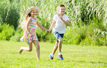 Obraz premium two friendly children active playing and running outdoors
