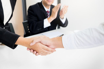 successful business team shaking hands with eachother in the office, job interview concept