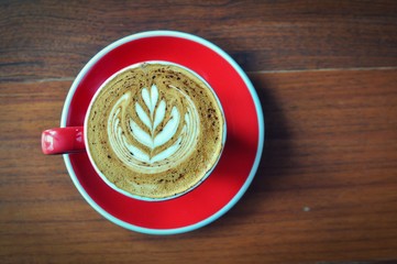 red  cup of hot coffee on wooden table in coffee shop,red cup