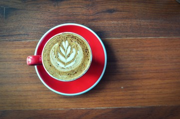 red  cup of hot coffee on wooden table in coffee shop,red cup