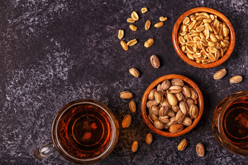 Beer and nuts on stone background.
