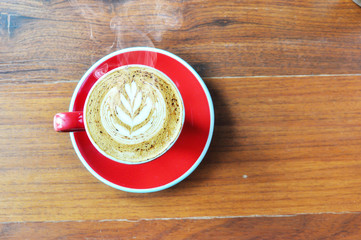 red  cup of hot coffee on wooden table in coffee shop,red cup