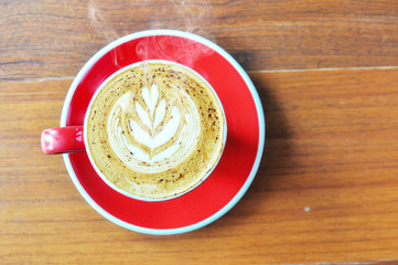 red  cup of hot coffee on wooden table in coffee shop,red cup