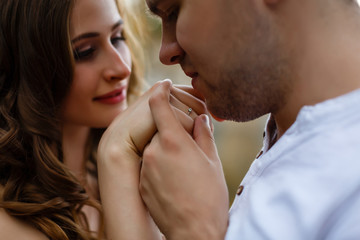 Obraz na płótnie Canvas the man gave his girl a wedding ring, man kisses a woman's hand, proposition