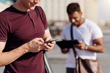 Close up of male hands that holding telephone