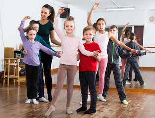 Obraz premium diligent little boys and girls dancing pair dance