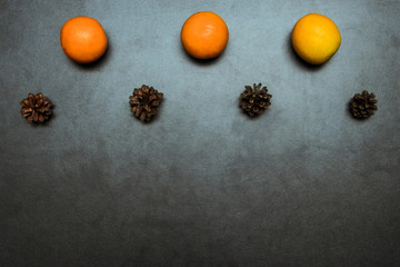 Christmas background with fur-tree branches, cones, dried oranges,Still life of Christmas accessories and stuff. Mittens - top view