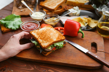 the hostess prepares a sandwich on a wooden table for guests
