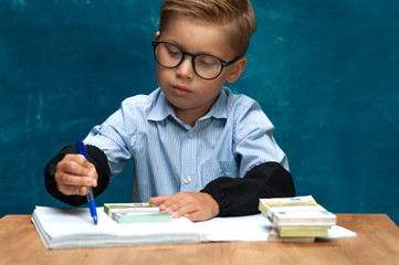Little child wearing eyeglasses with cash in hands