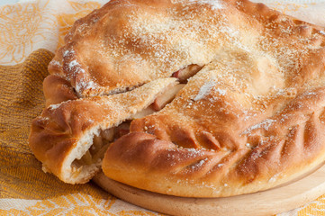 round pie with filling on a table