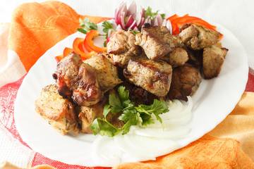 Beef pork barbecue kebab on skewer on a white plate