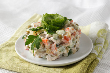 Russian salad Olivier on a white plate