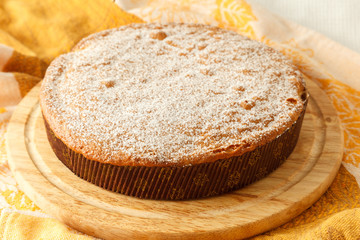 Sweet round pie with filling on a table