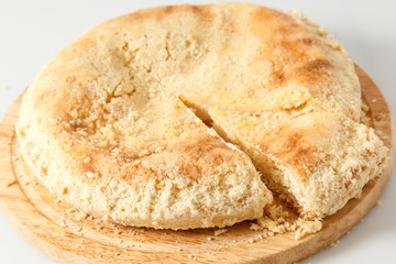 Sweet round pie with filling on a table