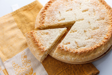 Sweet round pie with filling on a table