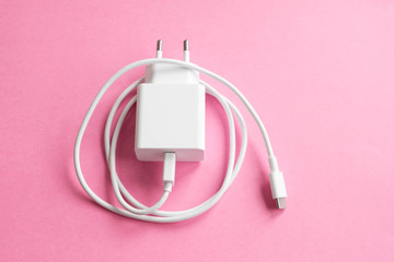Charger for smartphone or tablet on pink background