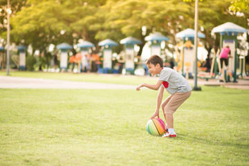 Little boy playing ball in the park