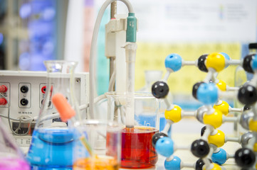 Asian scientists are experimenting with measuring pH in a chemical laboratory.