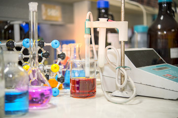 Asian scientists are experimenting with measuring pH in a chemical laboratory.