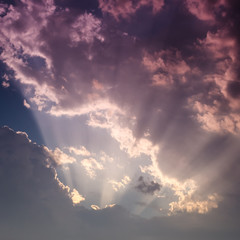Naklejka na ściany i meble Rays of light colorful clouds on sunset sky