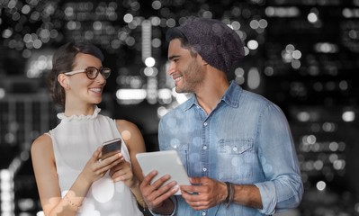 Composite image of smiling woman and man holding a phone and