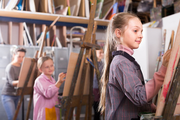 Female teenager practicing their skills during painting