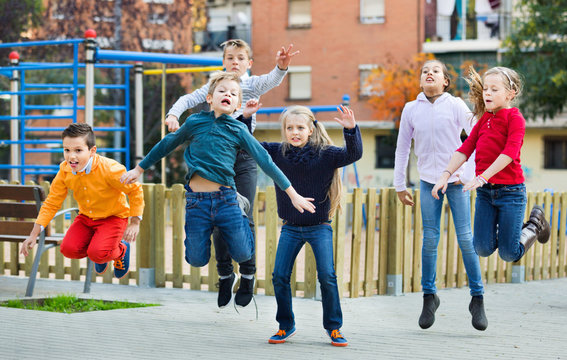 Happy kids having fun and jumping up